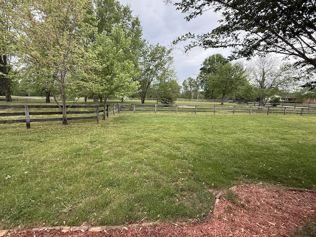 view of yard featuring fence and a rural view