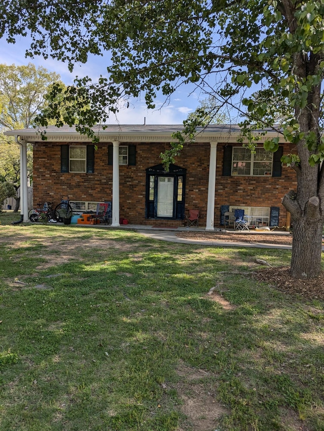 view of front of property with a front lawn and brick siding