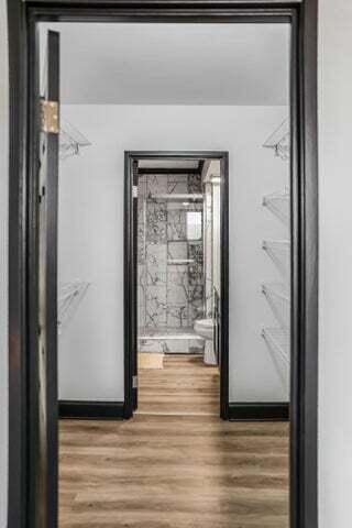 interior space with baseboards and wood finished floors