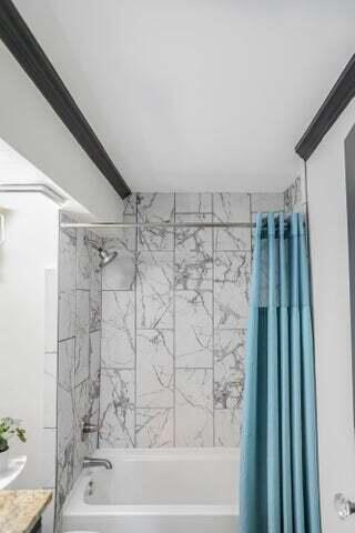 bathroom featuring shower / bath combination with curtain and vanity