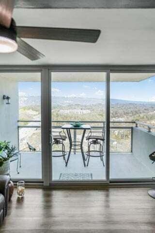 interior space featuring a ceiling fan, wood finished floors, and floor to ceiling windows