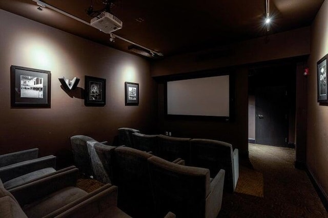 carpeted cinema room with rail lighting