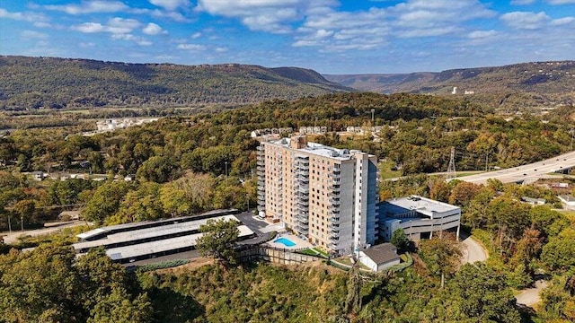 birds eye view of property featuring a mountain view and a wooded view