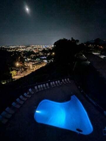 pool at twilight featuring a fenced in pool