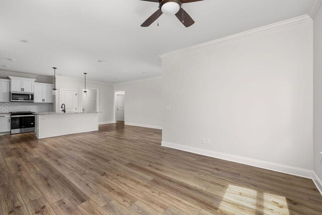 1571 Whisper Winds Ln Unit 42, Ooltewah, TN 37363 - unfurnished living room with a ceiling fan, crown molding, and wood finished floors