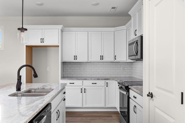 1571 Whisper Winds Ln Unit 42, Ooltewah, TN 37363 - kitchen with stainless steel appliances, white cabinetry, wood finished floors, decorative light fixtures, and ornamental molding