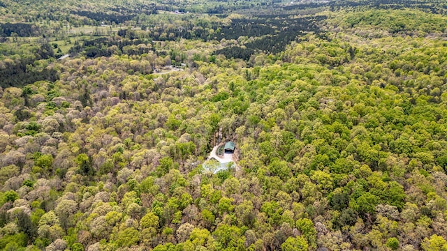 birds eye view of property featuring a view of trees