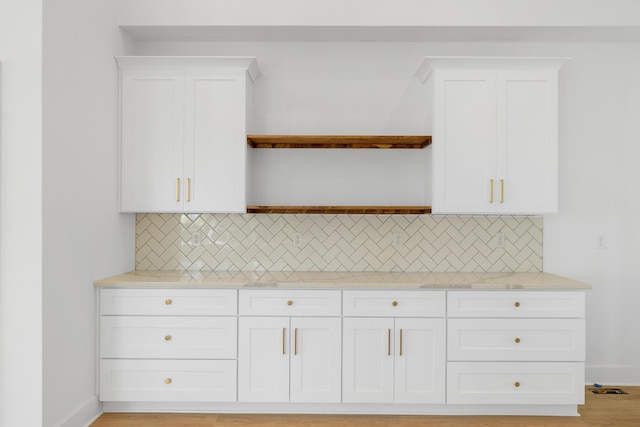kitchen featuring white cabinets, light countertops, and decorative backsplash