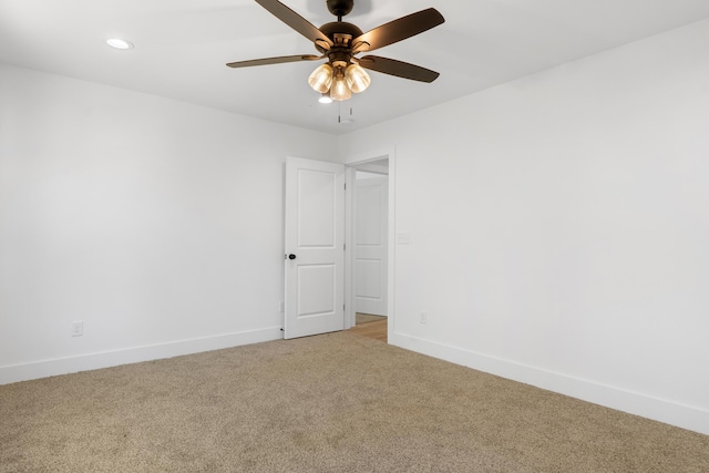 carpeted empty room featuring recessed lighting, a ceiling fan, and baseboards