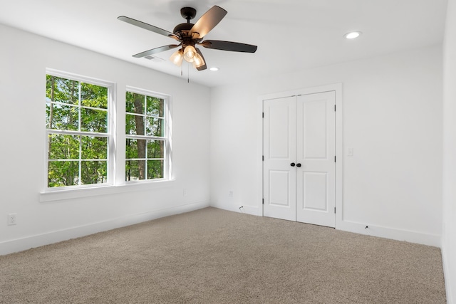 spare room featuring ceiling fan, carpet floors, visible vents, and recessed lighting