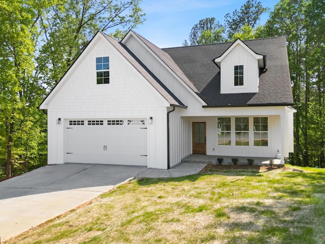 modern farmhouse style home featuring board and batten siding, roof with shingles, a front yard, and driveway