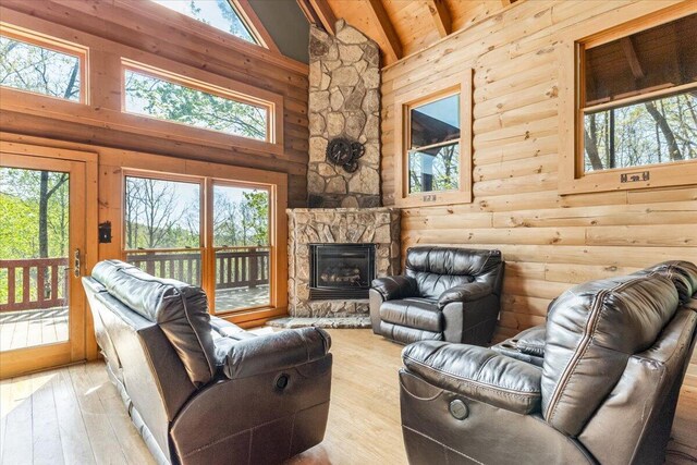 159 Eagle Creek Trl, Rising Fawn, GA 30738 - living room with high vaulted ceiling, a stone fireplace, beam ceiling, and hardwood / wood-style flooring