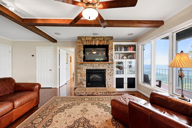 living area featuring a fireplace, wood finished floors, beam ceiling, and a ceiling fan