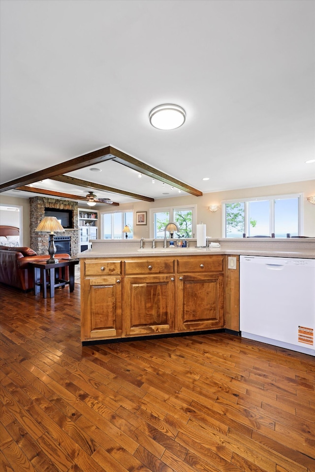 kitchen featuring dark wood finished floors, dishwasher, beam ceiling, and open floor plan