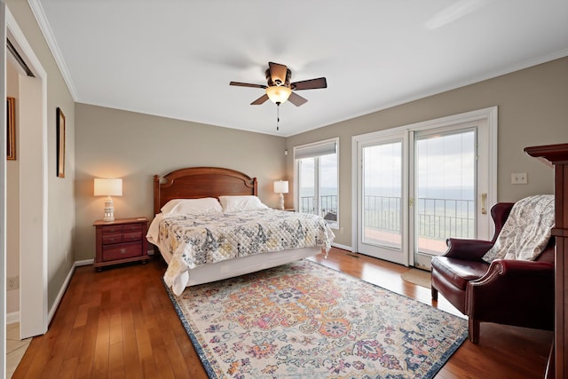 bedroom with hardwood / wood-style floors, crown molding, and access to exterior