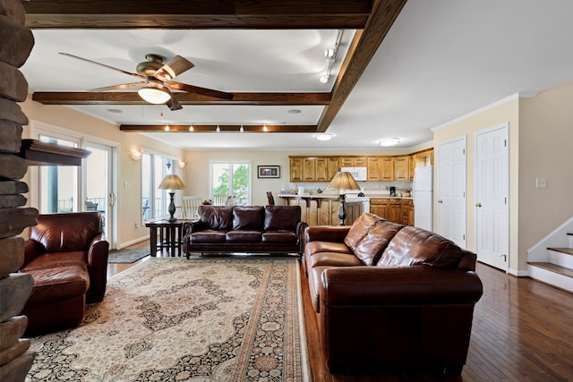 living room with baseboards, beamed ceiling, a ceiling fan, stairs, and dark wood-type flooring