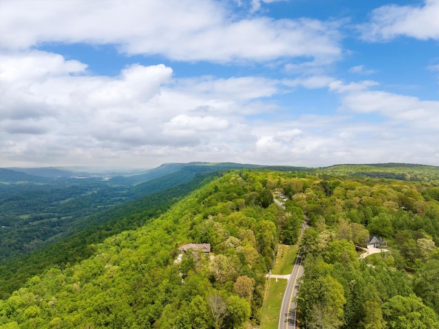 drone / aerial view featuring a wooded view