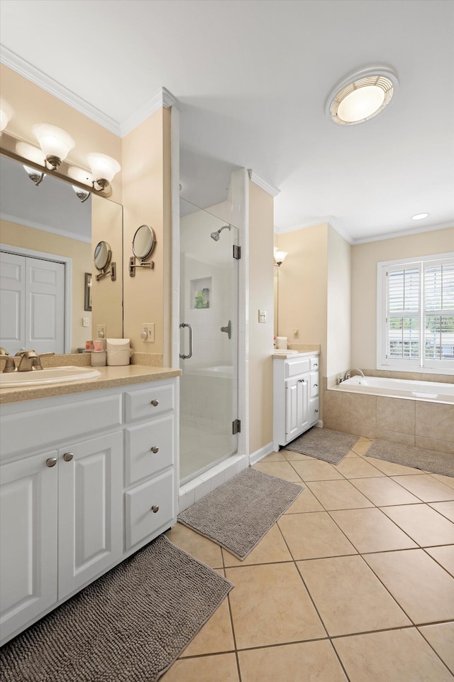 full bath with tile patterned flooring, vanity, ornamental molding, a garden tub, and a stall shower