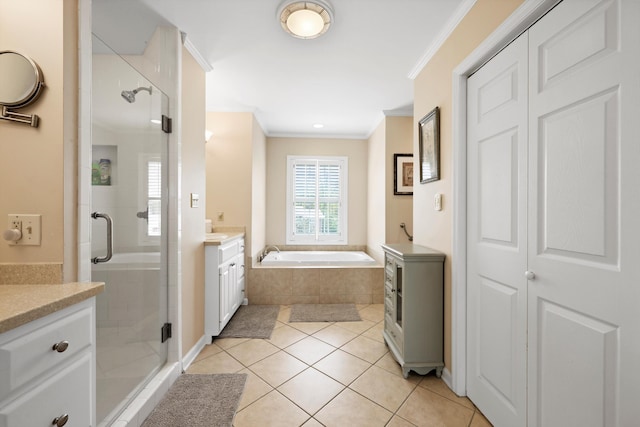 bathroom featuring a stall shower, a bath, vanity, ornamental molding, and tile patterned flooring