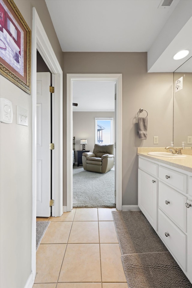 bathroom with baseboards, visible vents, tile patterned flooring, and vanity