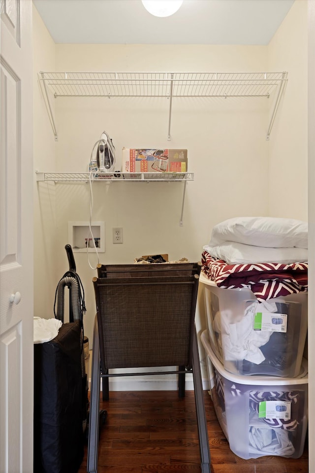 laundry area featuring wood finished floors and washer hookup