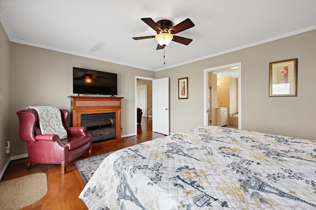 bedroom with baseboards, ornamental molding, wood finished floors, and a fireplace