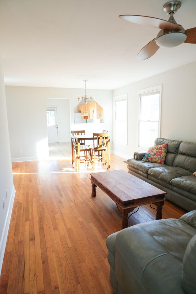 1728 Mitchell Ave, Chattanooga, TN 37408 - living room featuring a ceiling fan, light wood-style floors, a chandelier, and baseboards