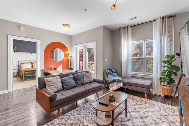 living area with plenty of natural light, wood finished floors, and visible vents