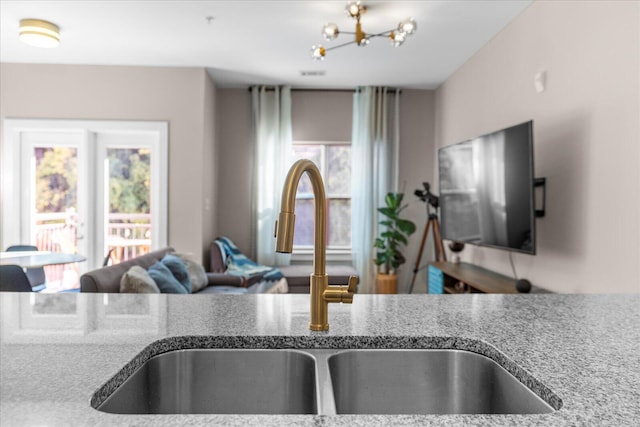 interior details featuring a chandelier and a sink