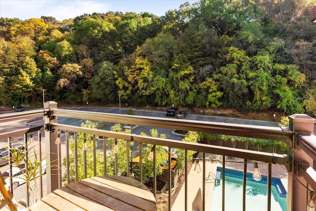 balcony featuring a view of trees