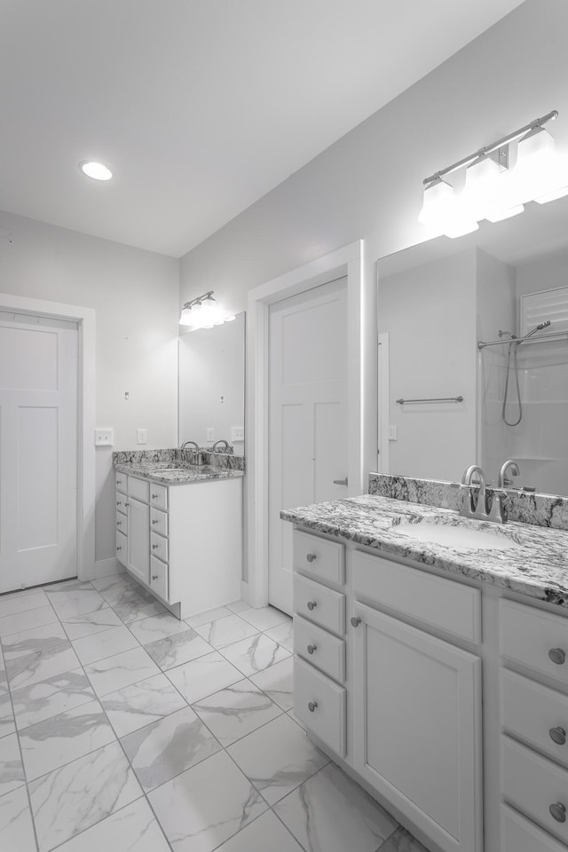 229 Courtland Crest Dr SW, Cleveland, TN 37311 - full bath with recessed lighting, two vanities, a shower, marble finish floors, and baseboards