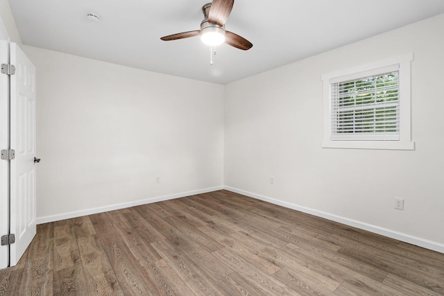 unfurnished room featuring baseboards, ceiling fan, and wood finished floors