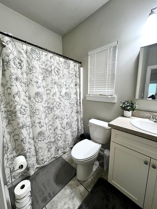 bathroom with vanity, toilet, and a shower with shower curtain