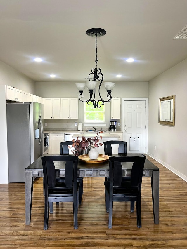 dining room with recessed lighting, dark wood finished floors, and a chandelier