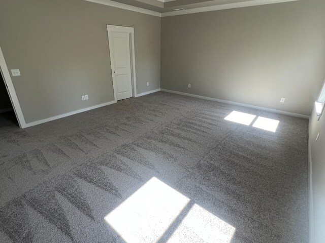 unfurnished room featuring carpet floors and baseboards