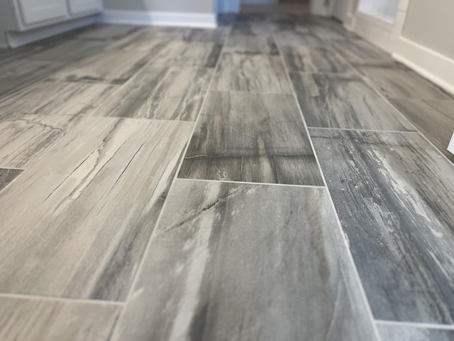 details featuring baseboards and wood finished floors