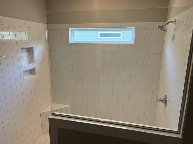 bathroom featuring plenty of natural light and walk in shower