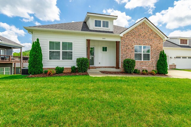 3495 Travertine Ln, Chattanooga, TN 37405 - view of front of home featuring concrete driveway, a shingled roof, a front lawn, brick siding, and a garage