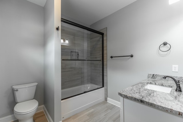 3495 Travertine Ln, Chattanooga, TN 37405 - bathroom featuring wood finished floors, shower / bath combination with glass door, toilet, vanity, and baseboards