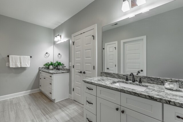 3495 Travertine Ln, Chattanooga, TN 37405 - bathroom featuring two vanities, visible vents, baseboards, and a sink