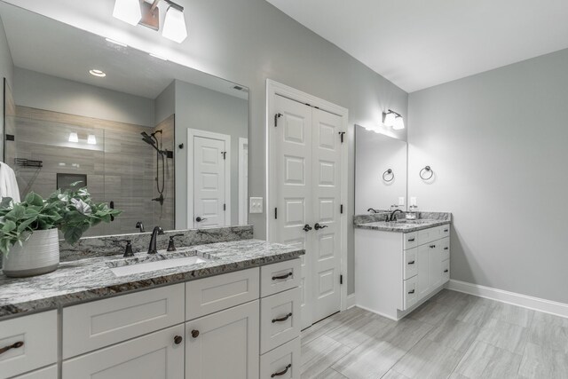 3495 Travertine Ln, Chattanooga, TN 37405 - bathroom with two vanities, baseboards, a stall shower, and a sink