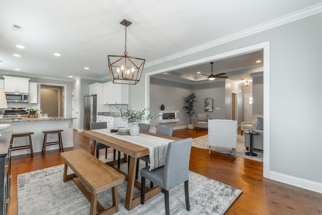 3495 Travertine Ln, Chattanooga, TN 37405 - dining space with crown molding, recessed lighting, dark wood-style flooring, and baseboards