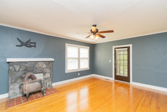 unfurnished living room featuring ornamental molding, baseboards, wood finished floors, and ceiling fan