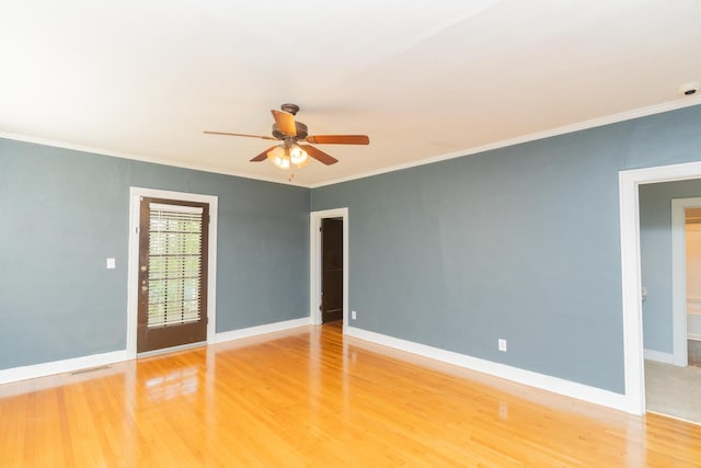 spare room featuring crown molding, a ceiling fan, baseboards, and light wood-style flooring