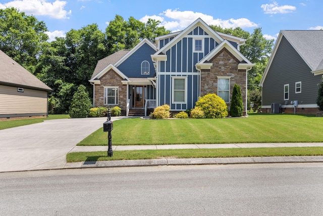8209 Robertsview Dr, Ooltewah, TN 37363 - craftsman-style home featuring stone siding, central air condition unit, a front lawn, and board and batten siding