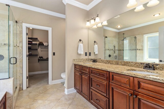 8209 Robertsview Dr, Ooltewah, TN 37363 - bathroom featuring double vanity, a shower stall, a spacious closet, and ornamental molding