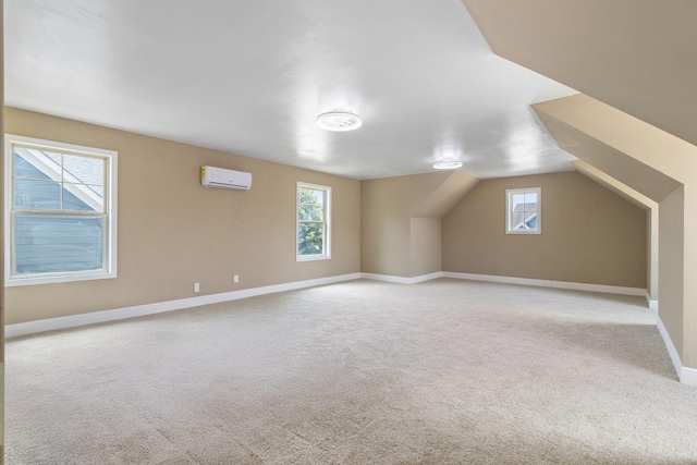 8209 Robertsview Dr, Ooltewah, TN 37363 - additional living space featuring an AC wall unit, carpet floors, healthy amount of natural light, baseboards, and vaulted ceiling