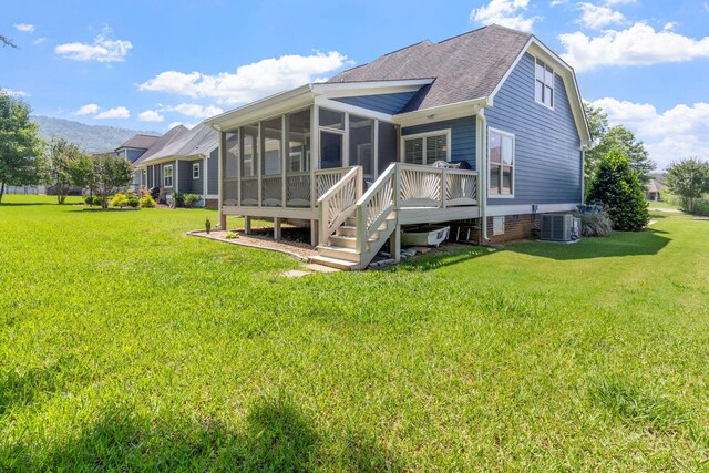 8209 Robertsview Dr, Ooltewah, TN 37363 - back of house featuring a sunroom, a lawn, central AC, and a shingled roof