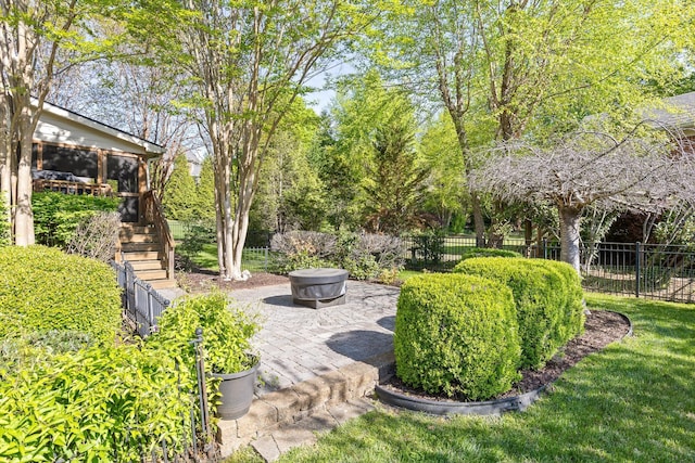view of yard with stairs, a patio area, fence, and a sunroom