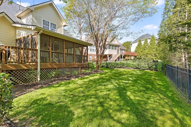 view of yard featuring a sunroom, a fenced backyard, and a wooden deck
